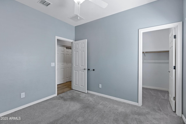 1272 W Joshua Tree Ave, Queen Creek, AZ 85140 - unfurnished bedroom featuring carpet, a spacious closet, baseboards, a closet, and ceiling fan