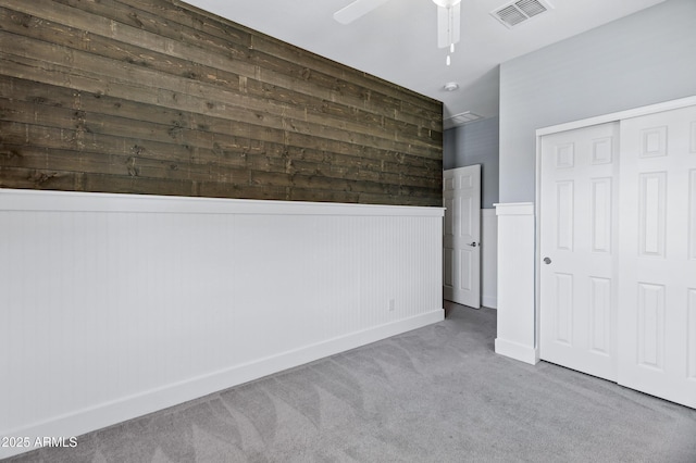 1272 W Joshua Tree Ave, Queen Creek, AZ 85140 - unfurnished bedroom featuring carpet floors, wainscoting, a closet, a ceiling fan, and baseboards