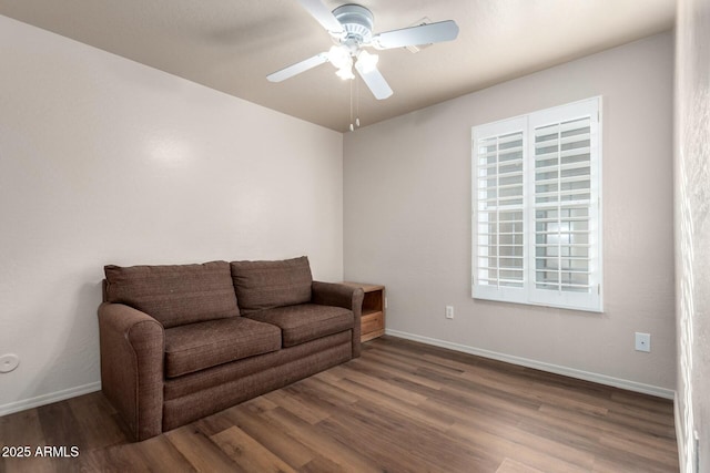 living room featuring ceiling fan and dark hardwood / wood-style flooring