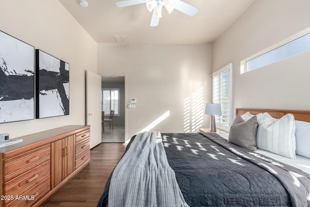 bedroom with ceiling fan and dark hardwood / wood-style flooring