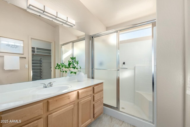 bathroom with vanity and an enclosed shower