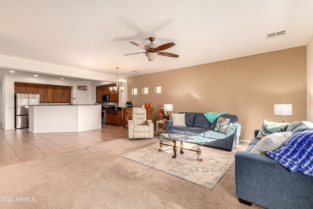 living room featuring light tile patterned flooring and ceiling fan with notable chandelier