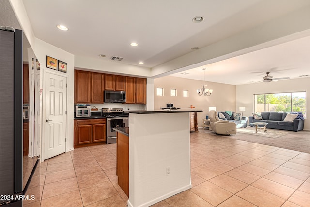 kitchen featuring decorative light fixtures, light tile patterned floors, stainless steel appliances, and ceiling fan with notable chandelier