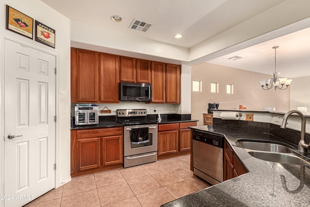 kitchen with sink, stainless steel appliances, a notable chandelier, pendant lighting, and light tile patterned flooring