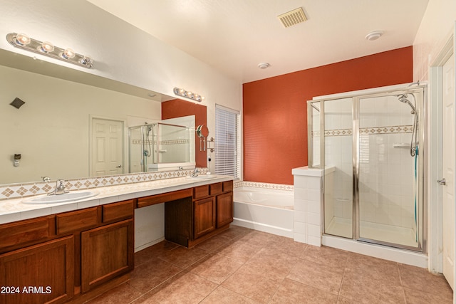 bathroom featuring tile patterned floors, plus walk in shower, and vanity