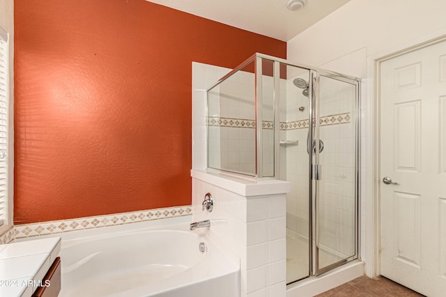 bathroom featuring tile patterned floors, vanity, and plus walk in shower