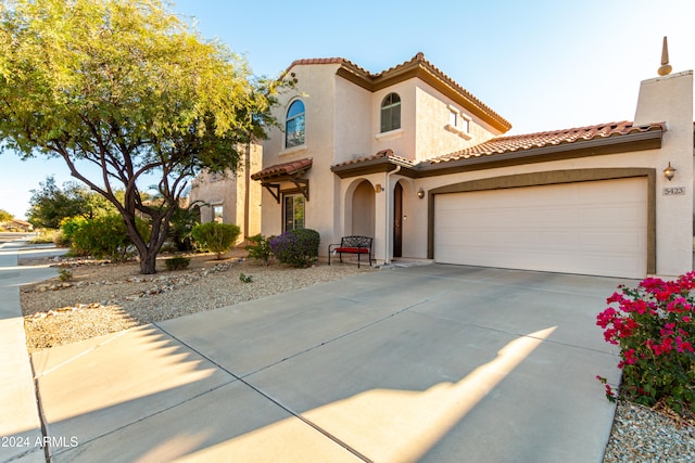 mediterranean / spanish-style home with a garage