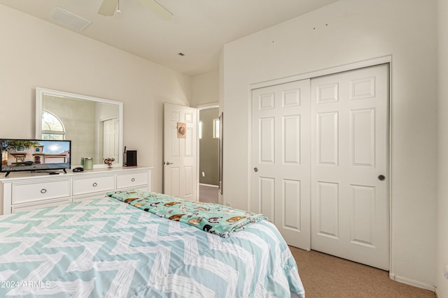 carpeted bedroom with a closet and ceiling fan