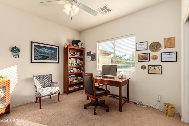 carpeted home office featuring ceiling fan