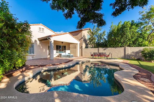 view of pool featuring ceiling fan and a patio area