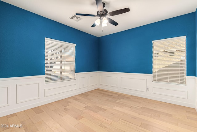 spare room with light hardwood / wood-style flooring and ceiling fan