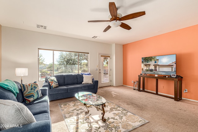 living room featuring light carpet and ceiling fan