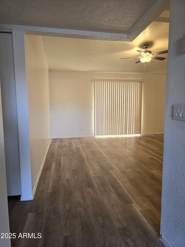 unfurnished room featuring dark hardwood / wood-style floors and ceiling fan