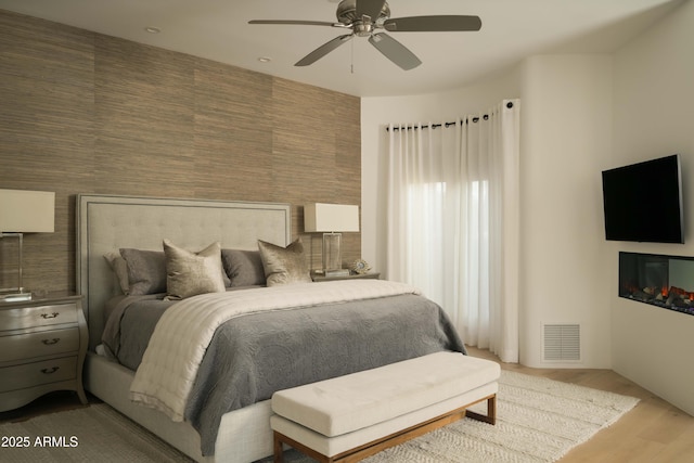 10040 E Happy Valley Rd Unit 1011, Scottsdale, AZ 85255 - bedroom with wood finished floors and a ceiling fan