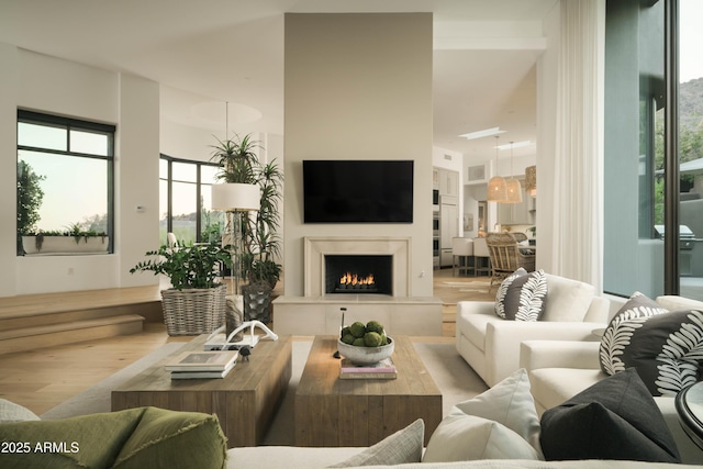 10040 E Happy Valley Rd Unit 1011, Scottsdale, AZ 85255 - living area with wood finished floors and a lit fireplace