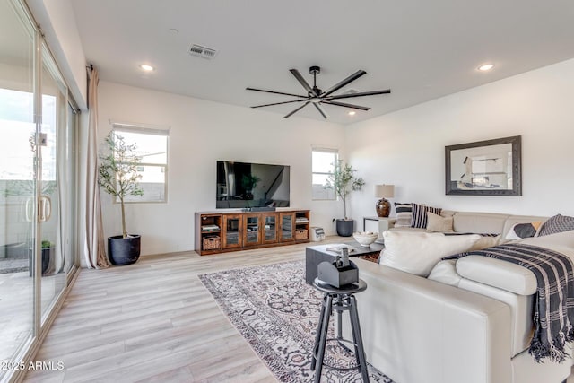 living room featuring recessed lighting, visible vents, and light wood-style floors