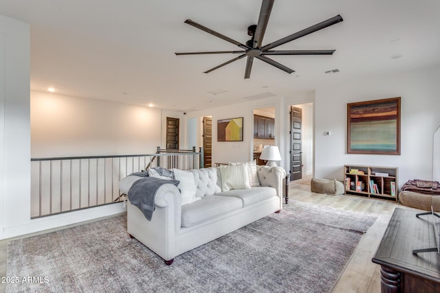 living room featuring a ceiling fan, light wood-type flooring, visible vents, and recessed lighting