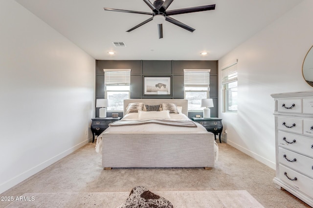 bedroom with visible vents, multiple windows, and baseboards