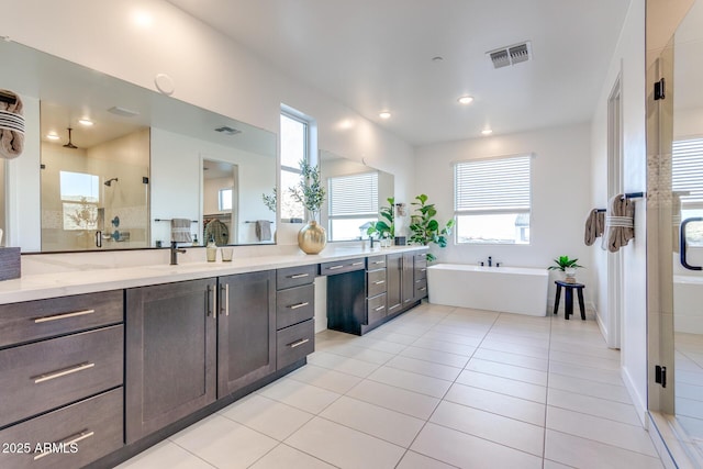 full bathroom with vanity, visible vents, a freestanding bath, tile patterned floors, and a stall shower