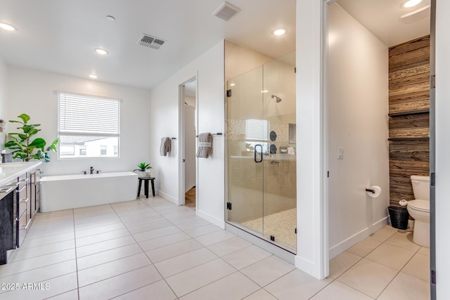 full bath featuring toilet, a stall shower, a soaking tub, and visible vents