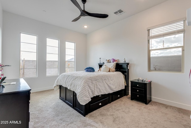 bedroom with visible vents, light carpet, and baseboards