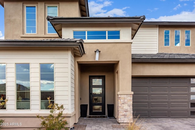 property entrance with stone siding and stucco siding