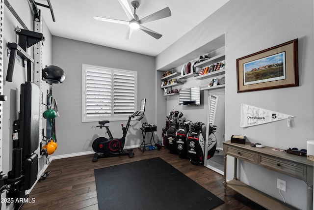 exercise area featuring dark wood finished floors, baseboards, and ceiling fan