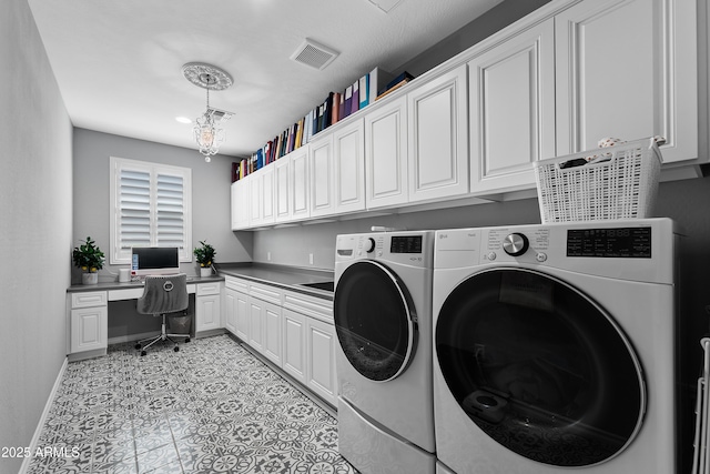 washroom with baseboards, visible vents, washer and dryer, and cabinet space