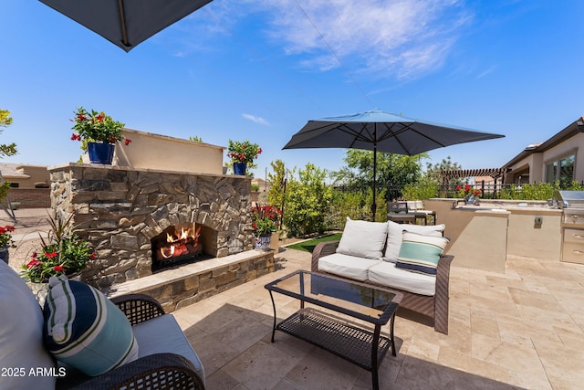 view of patio / terrace with an outdoor living space with a fireplace and area for grilling