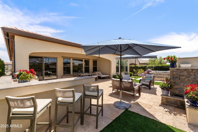 view of patio / terrace featuring an outdoor hangout area and outdoor dry bar