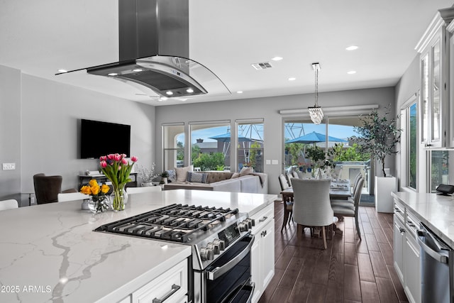 kitchen featuring white cabinets, open floor plan, stainless steel appliances, and visible vents