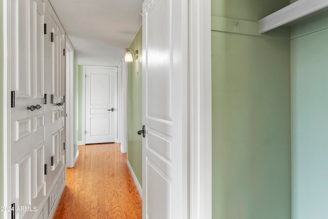 corridor with light hardwood / wood-style floors