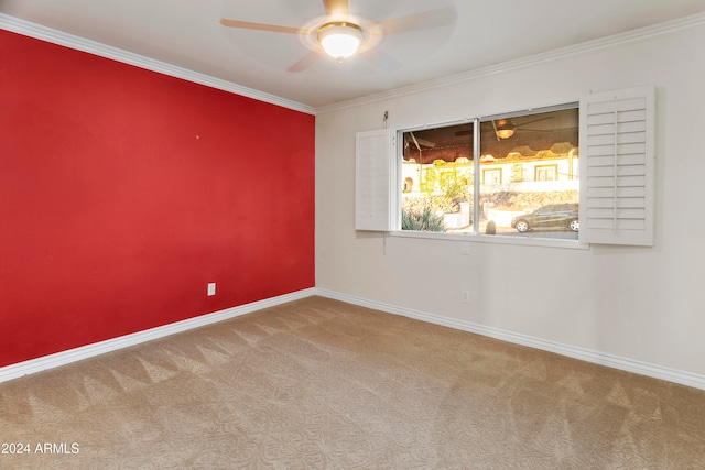 empty room with carpet flooring, ceiling fan, and ornamental molding