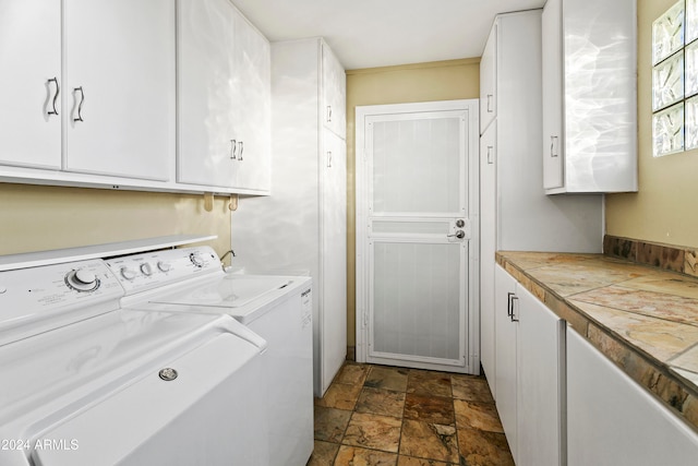 laundry room featuring cabinets and washing machine and clothes dryer