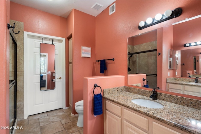15151 N Frank Lloyd Wright Blvd Unit 2086, Scottsdale, AZ 85260 - bathroom featuring a shower stall, stone finish flooring, and vanity