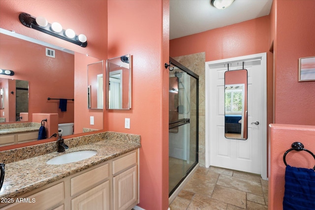 15151 N Frank Lloyd Wright Blvd Unit 2086, Scottsdale, AZ 85260 - bathroom with a stall shower, stone finish floors, vanity, and a textured wall