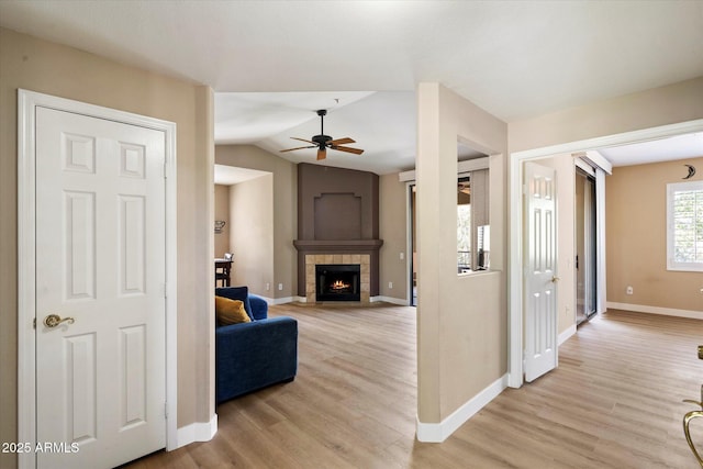 15151 N Frank Lloyd Wright Blvd Unit 2086, Scottsdale, AZ 85260 - living area featuring light wood-type flooring, a tile fireplace, a ceiling fan, and lofted ceiling