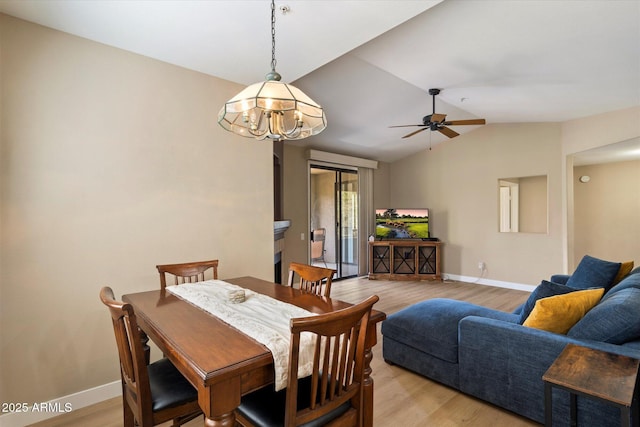 15151 N Frank Lloyd Wright Blvd Unit 2086, Scottsdale, AZ 85260 - dining area featuring vaulted ceiling, light wood-style flooring, ceiling fan, and a chandelier