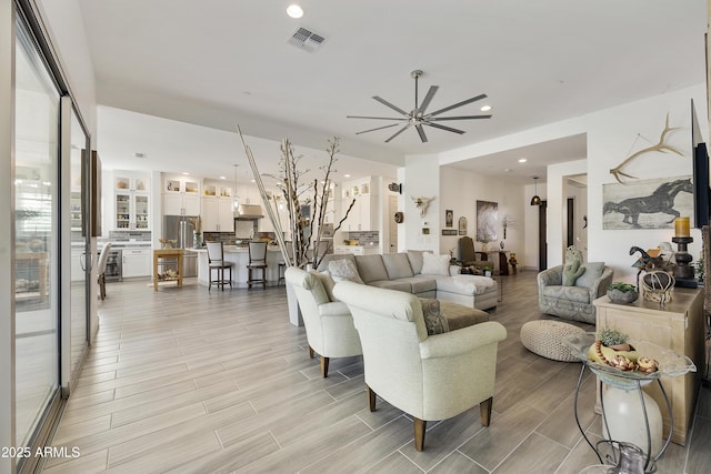 living room with ceiling fan and plenty of natural light