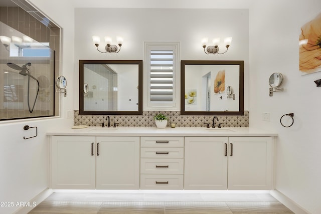 bathroom with decorative backsplash, vanity, an enclosed shower, and a healthy amount of sunlight