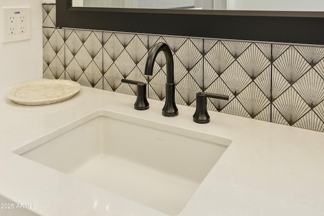 room details featuring backsplash and sink