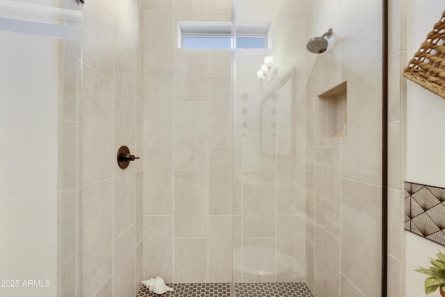 bathroom with a tile shower