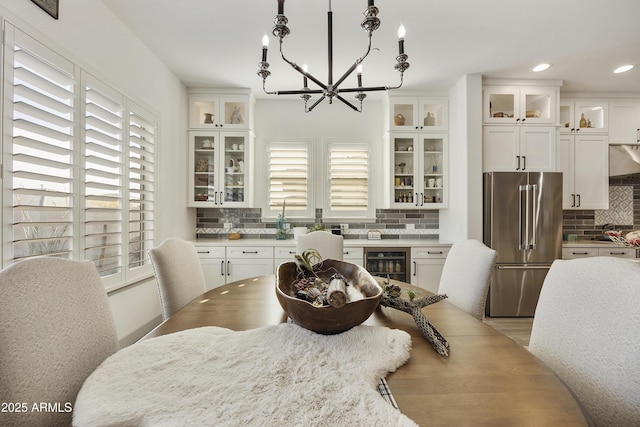 dining area featuring a chandelier and wine cooler