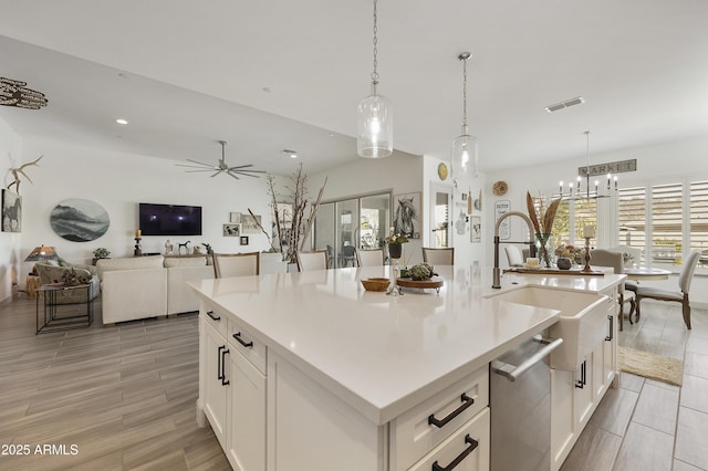 kitchen featuring hanging light fixtures, white cabinets, and a spacious island