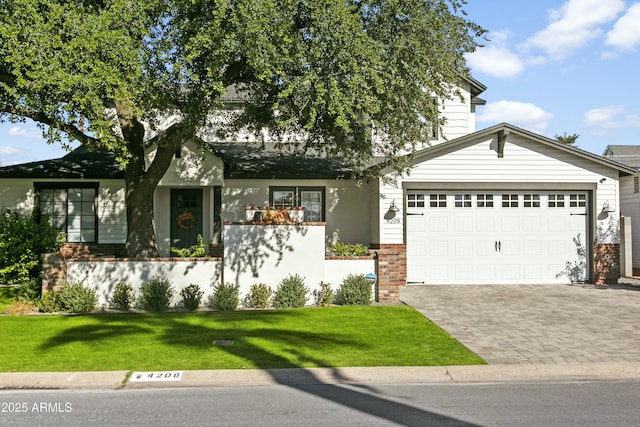 view of front facade with a garage, a front lawn, decorative driveway, and brick siding