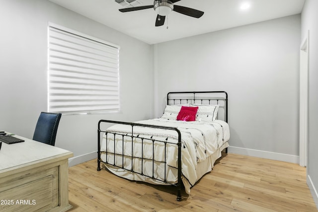 bedroom featuring visible vents, a ceiling fan, light wood-style flooring, and baseboards