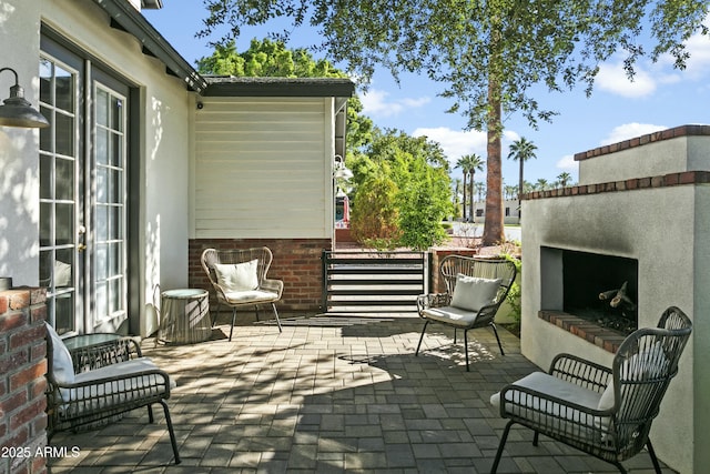 view of patio with an outdoor fireplace