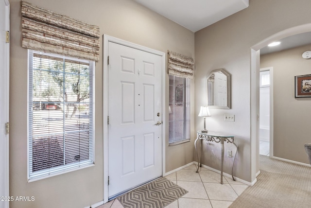 foyer entrance with light tile patterned floors