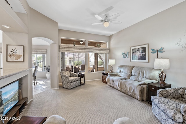 carpeted living room with ceiling fan