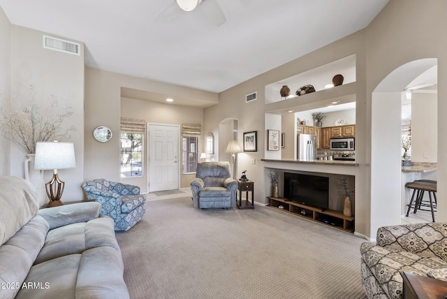 living room featuring light colored carpet and ceiling fan